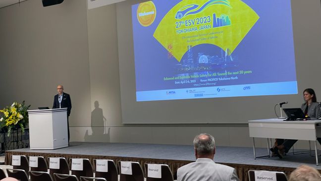 Man presenting at 27th ESV 2023 conference in Osaka, Japan