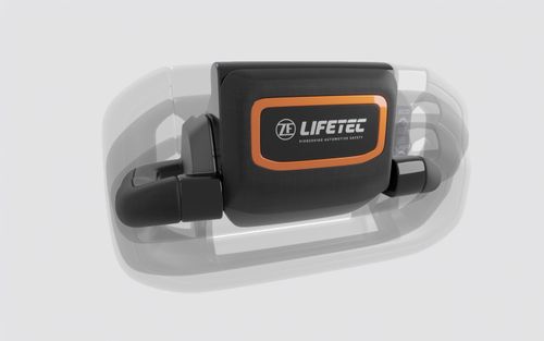 Das umwandelbare Lenkradkonzept von ZF Lifetec verfügt über ein zentrales Sicherheitsmodul mit orangefarbener Umrandung und dem ZF Lifetec-Logo, das mit transparenten Überzügen dargestellt wird, um das anpassbare Design zu veranschaulichen.