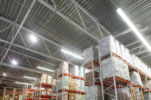 Warehouse with stacked boxes and bright lighting